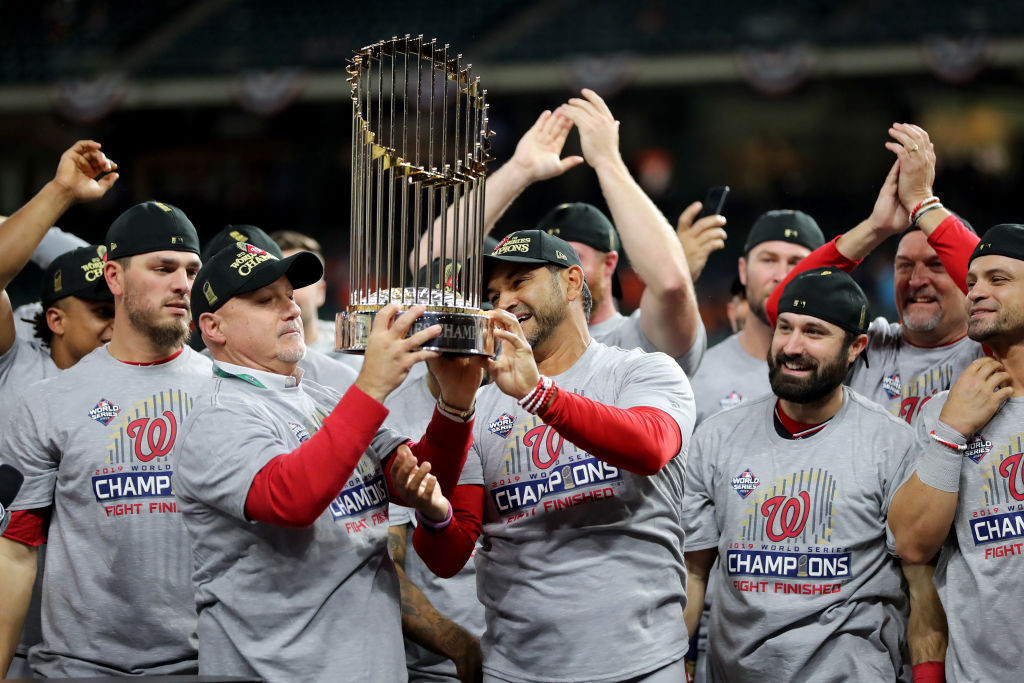 Rizzo and Martinez hoist commissioners trophy