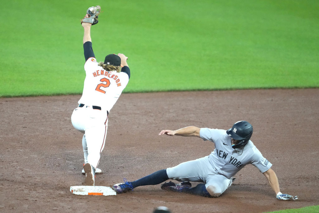 Henderson stretches to make play