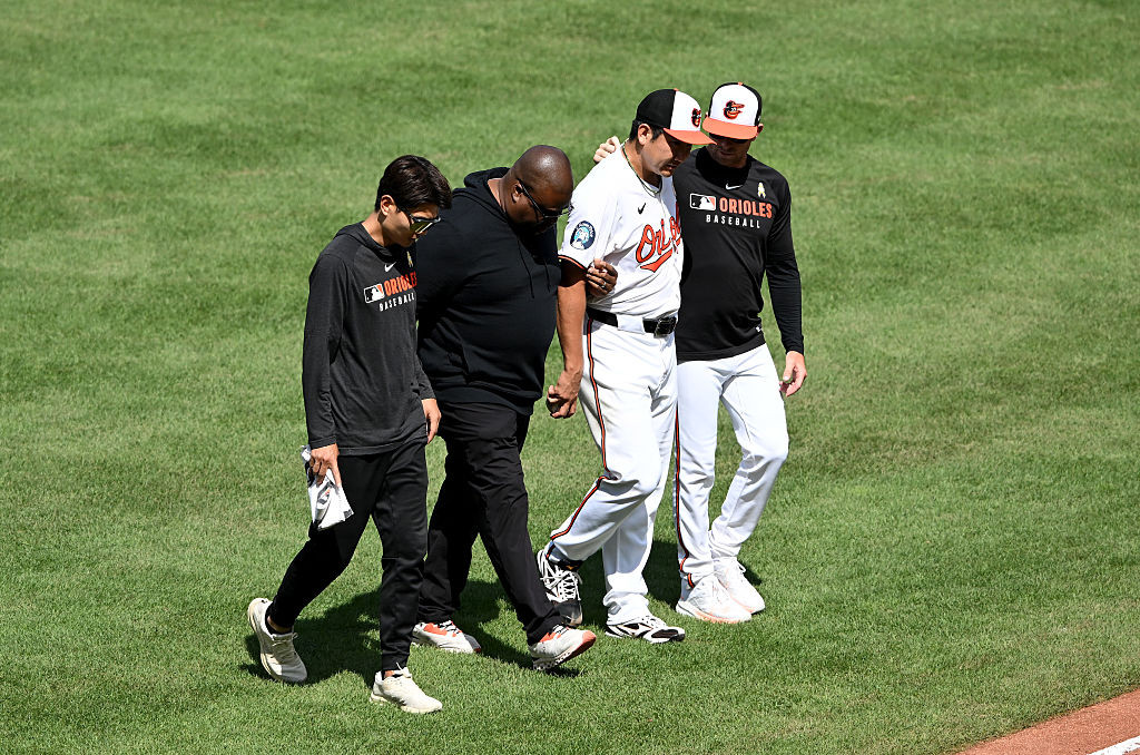 Sugano helped off the field